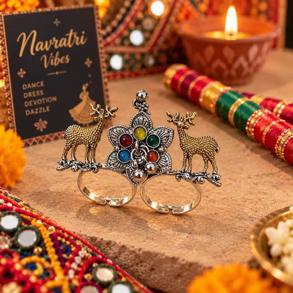 Two-tone fusion oxidised adjustable double-finger ring featuring golden deer motifs, multicolor center stones, and ghungroo drops.