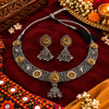 Peacock-inspired oxidised necklace set with ornate silver detailing, gold-tone accents and matching jhumka earrings