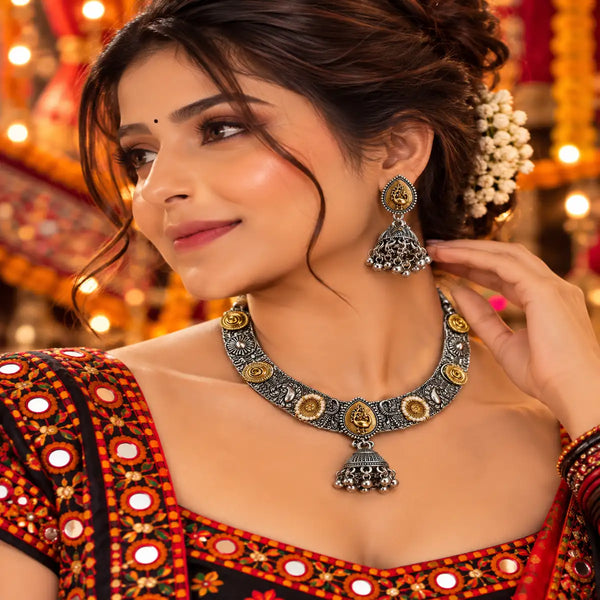 Peacock-inspired oxidised necklace set with ornate silver detailing, gold-tone accents and matching jhumka earrings