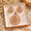 Rose gold American diamond pendant set featuring a teardrop openwork design, radiating metal lines, marquise-shaped stones and matching earrings.