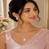Regal Lumière rose gold American Diamond pendant set with matching earrings featuring radiant rectangular stones and halo detailing.