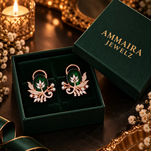 Rose gold floral statement earrings with oval centre stones, leaf motifs and sparkling zirconia detailing, available in ruby red, emerald green, blush pink and deep purple.