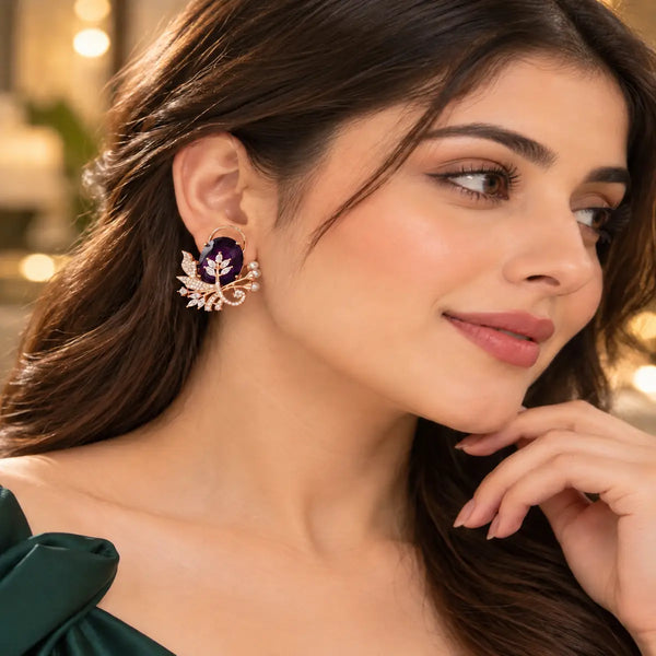 Rose gold floral statement earrings with oval centre stones, leaf motifs and sparkling zirconia detailing, available in ruby red, emerald green, blush pink and deep purple.