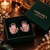 Rose gold floral statement earrings with oval centre stones, leaf motifs and sparkling zirconia detailing, available in ruby red, emerald green, blush pink and deep purple.