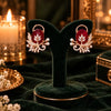 Rose gold floral statement earrings with oval centre stones, leaf motifs and sparkling zirconia detailing, available in ruby red, emerald green, blush pink and deep purple.