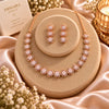 Rose gold Cubic Zirconia round link necklace set with matching three-tier round dangling earrings, featuring sparkling circular stone detailing.