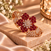 Rose gold premium brass floral cuff bracelet featuring red or purple zirconia petal clusters, clear marquise-shaped stones and sparkling detailing.