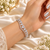 Silver-tone premium brass bracelet featuring clear zirconia teardrop stones and delicate sparkling accents