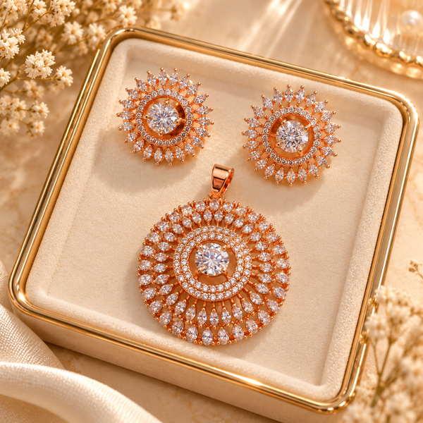 Rose gold American diamond pendant set featuring a circular halo pendant with a central clear stone, marquise-shaped accents and matching sunburst earrings.