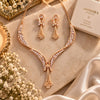Triphool V-Jaal American Diamond CZ necklace set for women featuring a curved V-shaped brass necklace, floral centre, three hanging chains and matching dangling earrings.