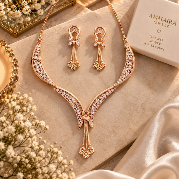 Triphool V-Jaal American Diamond CZ necklace set for women featuring a curved V-shaped brass necklace, floral centre, three hanging chains and matching dangling earrings.